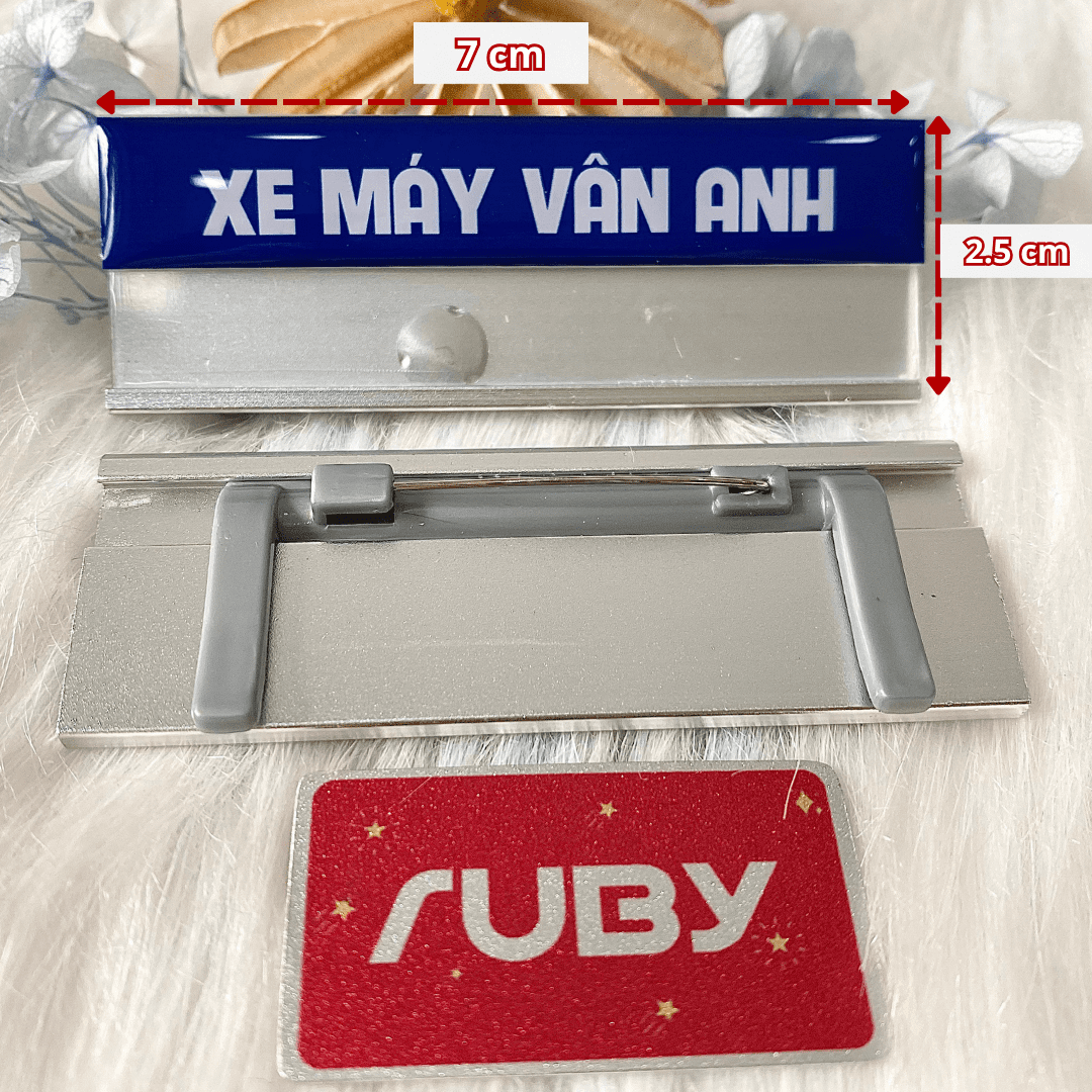 Kích thước chuẩn 7cm x 2.5cm của bảng tên nhôm nền xanh gài áo in logo Xe Máy Vân Anh.